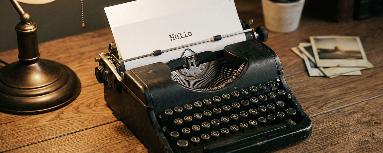 Vintage typewriter with a hello note on a wooden desk
