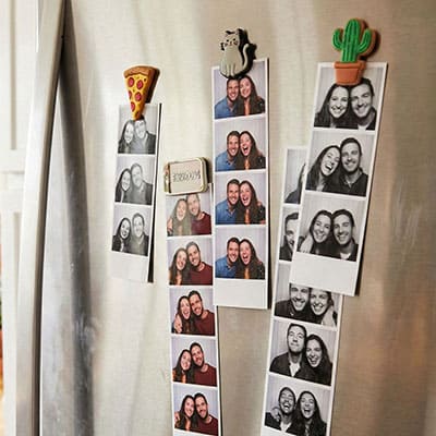 Vertical photo strips on fridge door as magnets