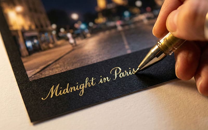 Writing with gold pen on black border