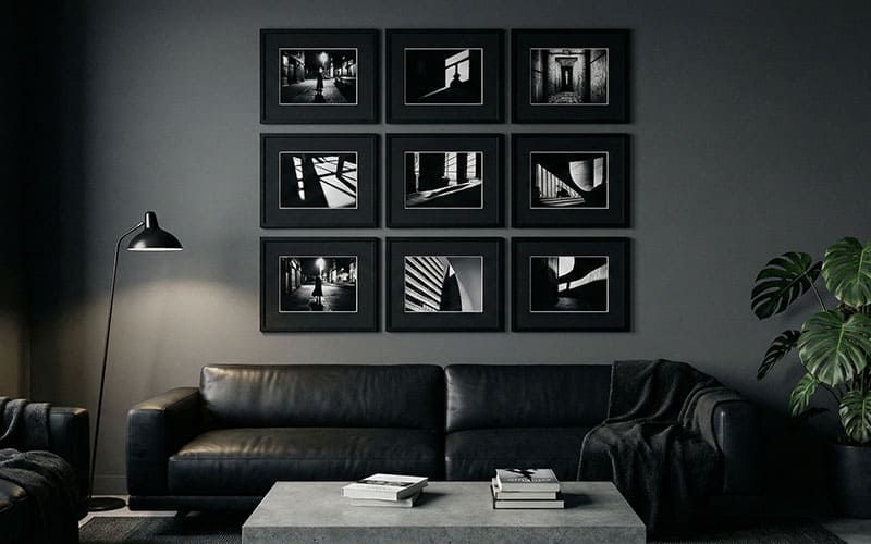 Black gallery wall with noir photos