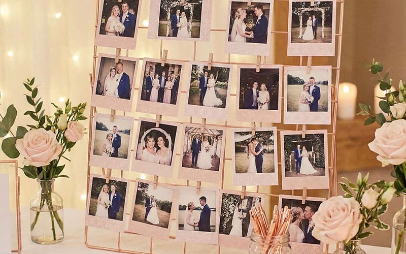 Blush pink wedding photo display with rose gold accents