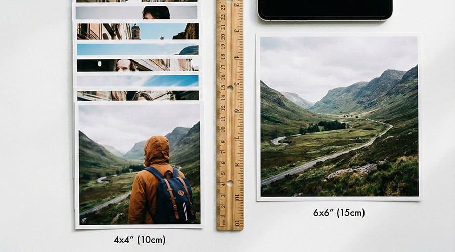 Comparison of 4x4 and 6x6 inch square photo prints with ruler for scale