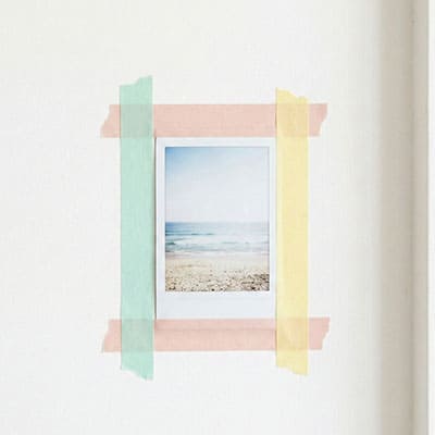 Instant photo taped to wall with colorful washi tape frame