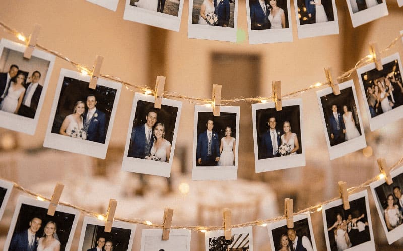 Wedding photo garland with fairy lights and wooden clips